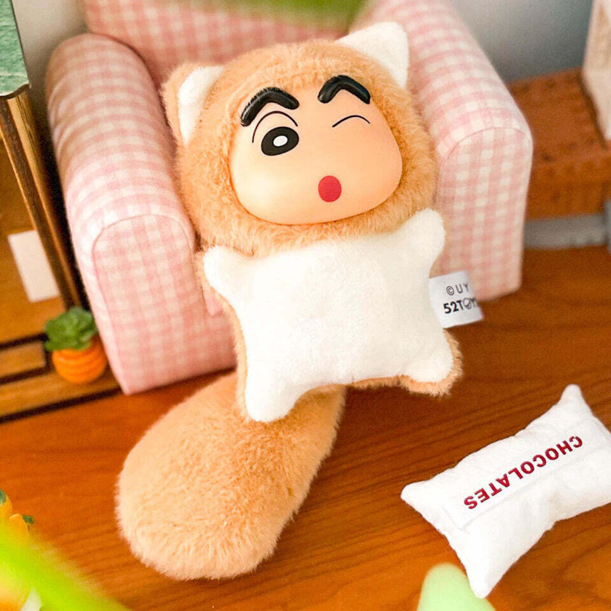 Little Lion plush charm with a soft mane resting on wood