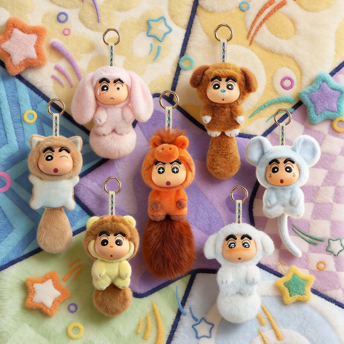 Crayon Shin-chan Big Tails Series 2 plush charms displayed on a colourful play mat