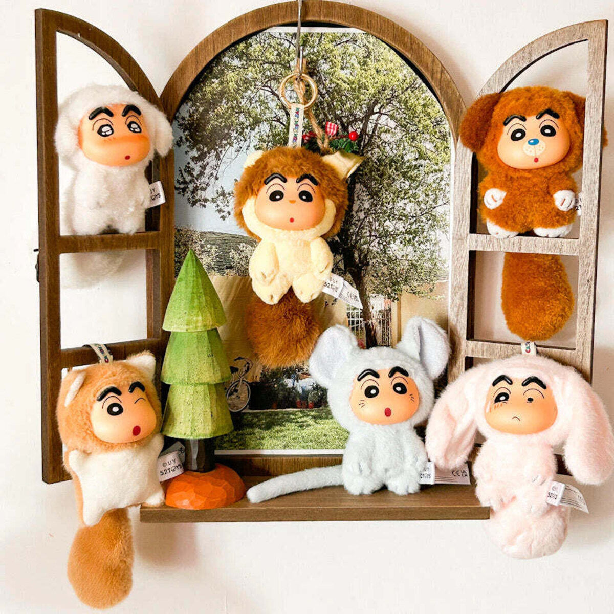 Big Tails Series 2 charms displayed in a wooden mirror shelf