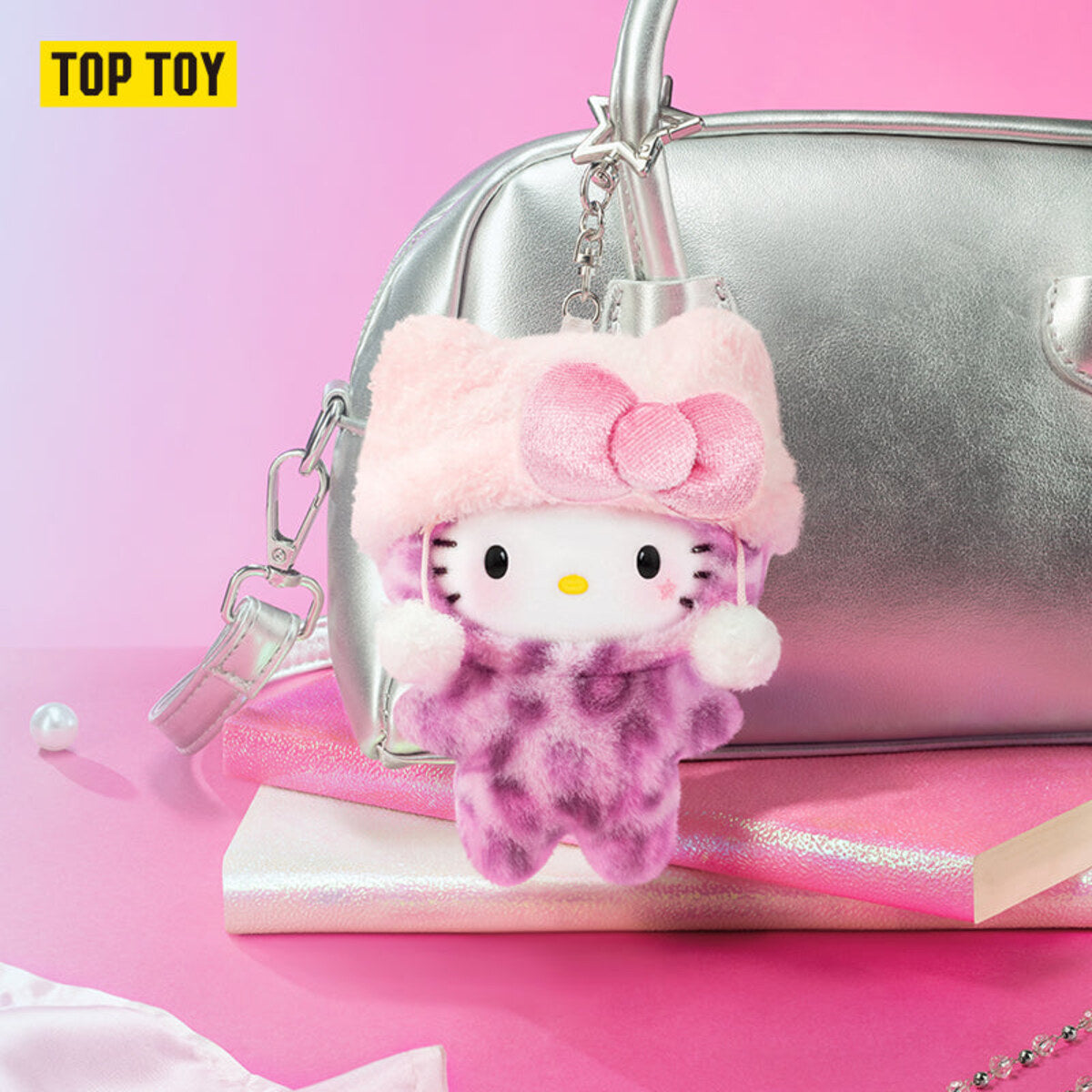 Hello Kitty Leopard Series plush charm clipped on a silver handbag