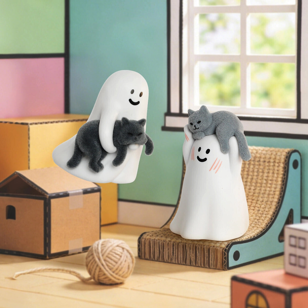 Two GHODY ghosts on a cat tower - one glowing green holding a gray cat - with a ball of yarn